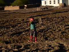 14 Child In Colourful Clothing Carrying Shovel Through The Tilled Fields At Sunset In Yilik Village On The Way To K2 China Trek